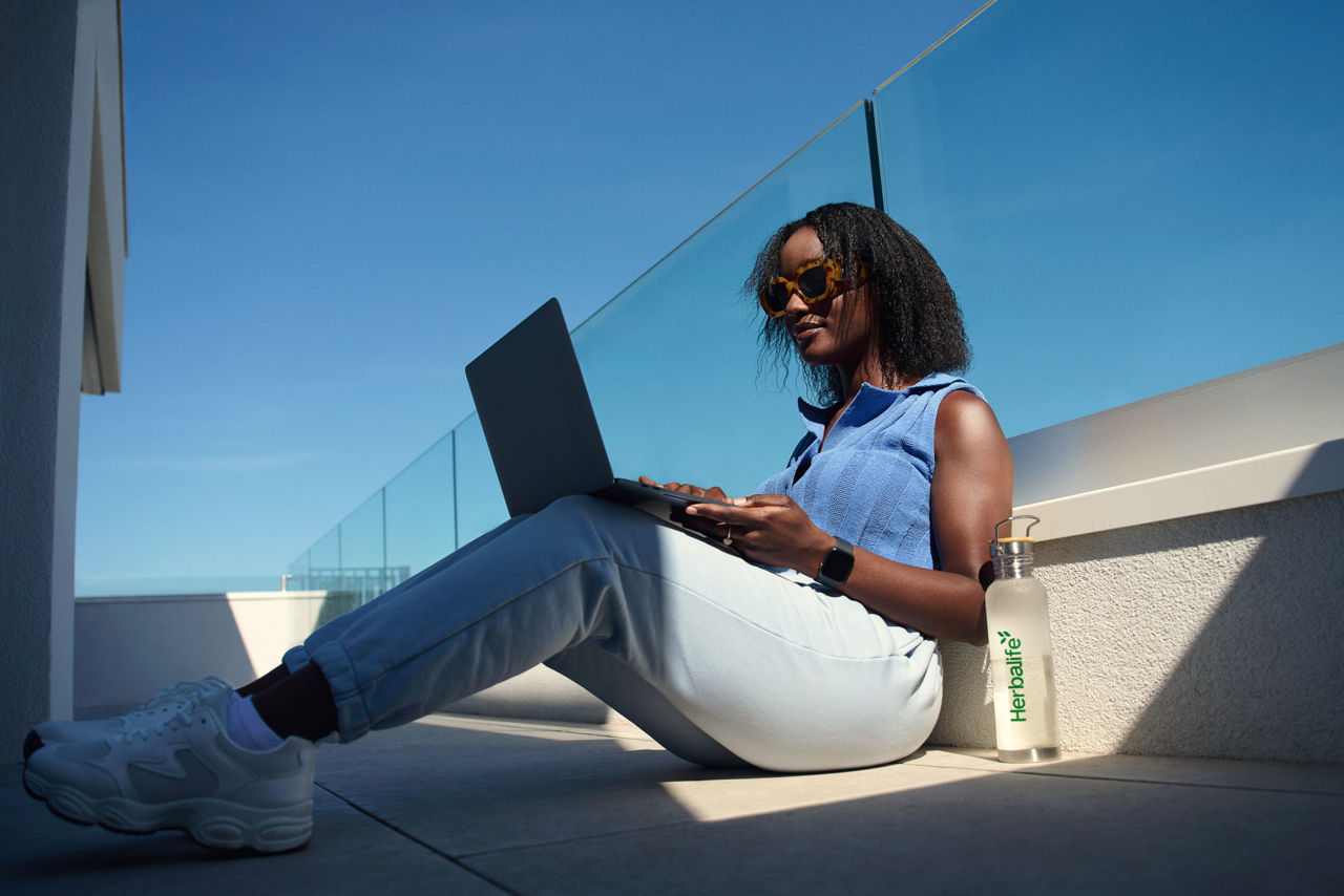 Woman working on laptop outdoors