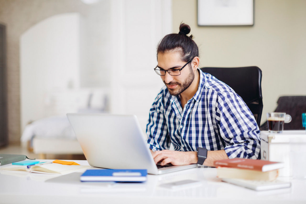 Young man working on computer at home